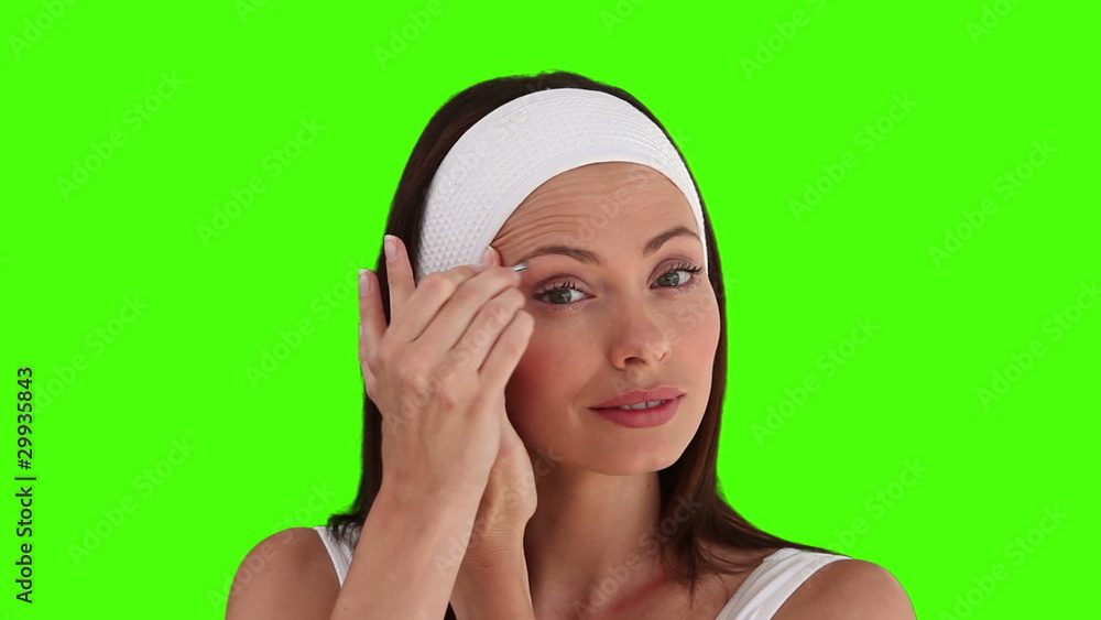 Dark-haired woman putting on make-up Dark-haired woman putting on make-up