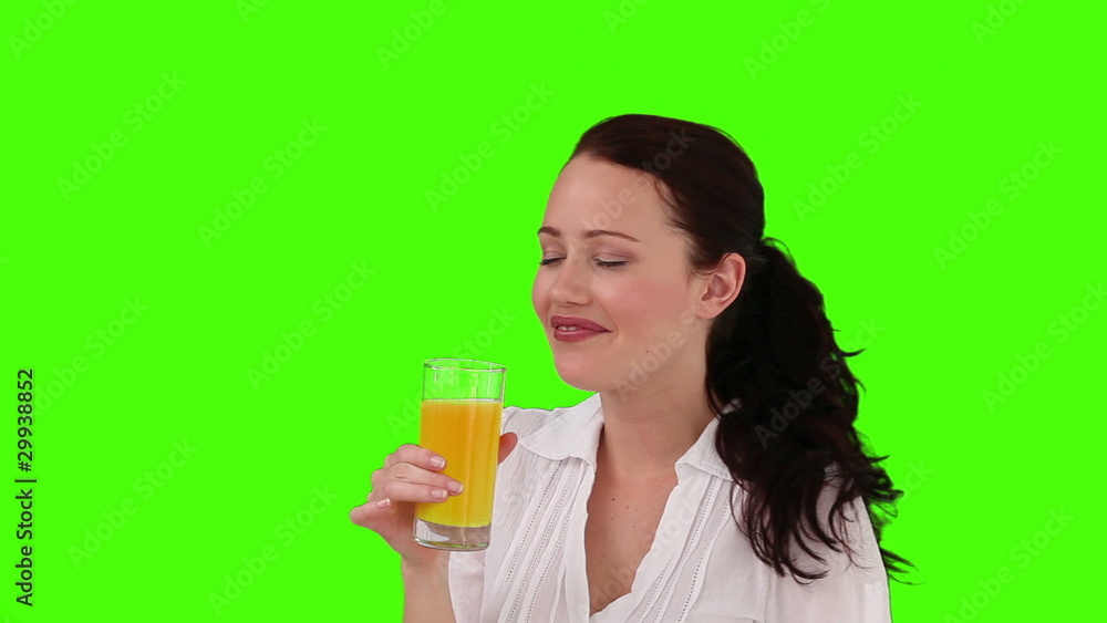 Dark-haired woman drinking orange juice Dark-haired woman drinking orange juice