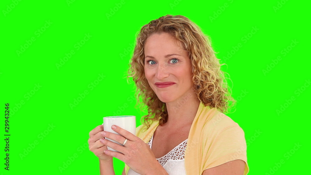 Woman looking at the camera with a cup of tea Woman looking at the camera with a cup of tea