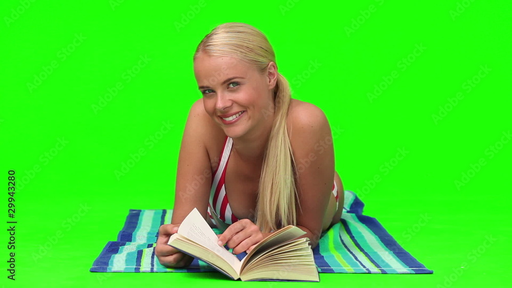Wonderful blond woman reading a book on the beach Wonderful blond woman reading a book on the beach