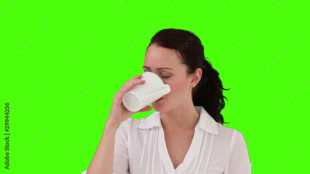 Brunette woman drinking a cup of tea Brunette woman drinking a cup of tea