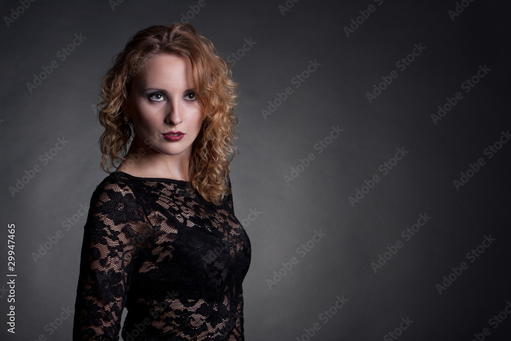 Young gorgeous model in a lace dress, a black background Young gorgeous model in a lace dress, a black background