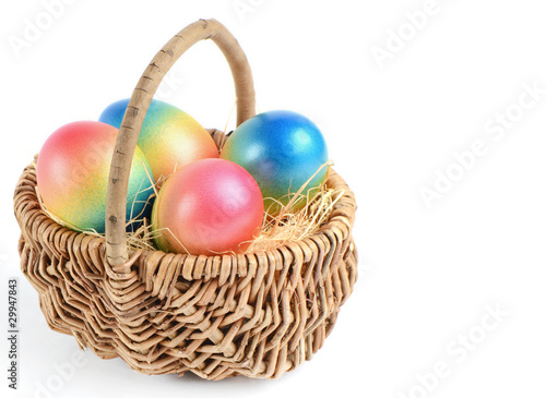 Colorful painted easter eggs in brown basket