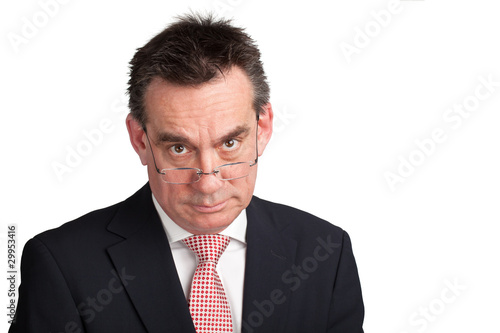 Slika na platnu Stern Businessman looking over Spectacles