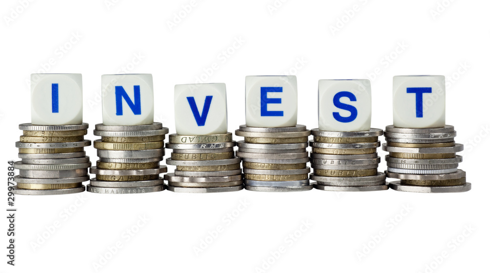 Stacks of coins with the word INVEST isolated on white