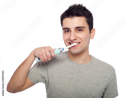 Young man brushing teeth
