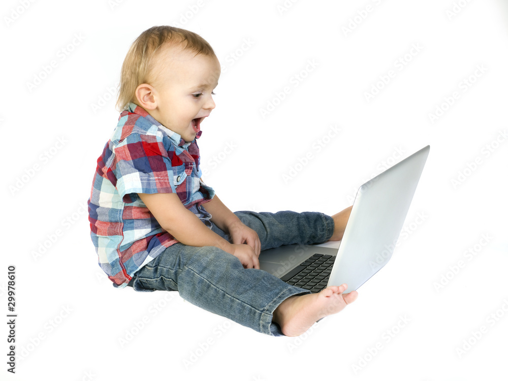 happy baby boy using a laptop computer happy baby boy using a laptop computer