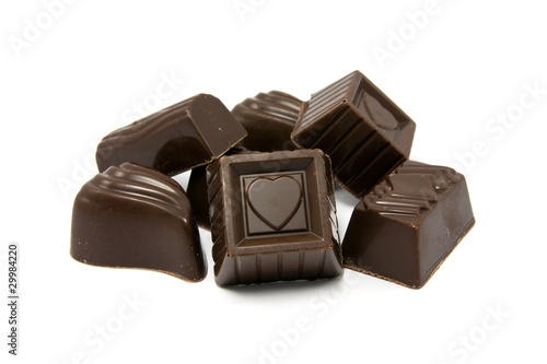 dark assorted chocolate pralines on white background