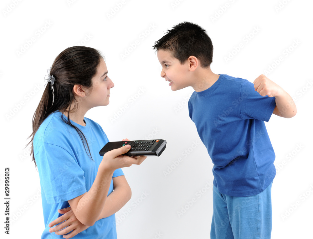 Brother and sister fighting over the TV remote control isolated. Brother and sister fighting over the TV remote control isolated.