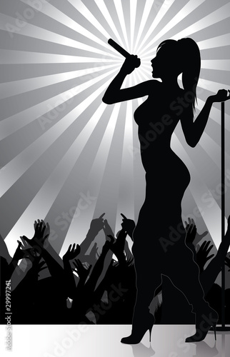 pop singer performing on stage with crowd cheering