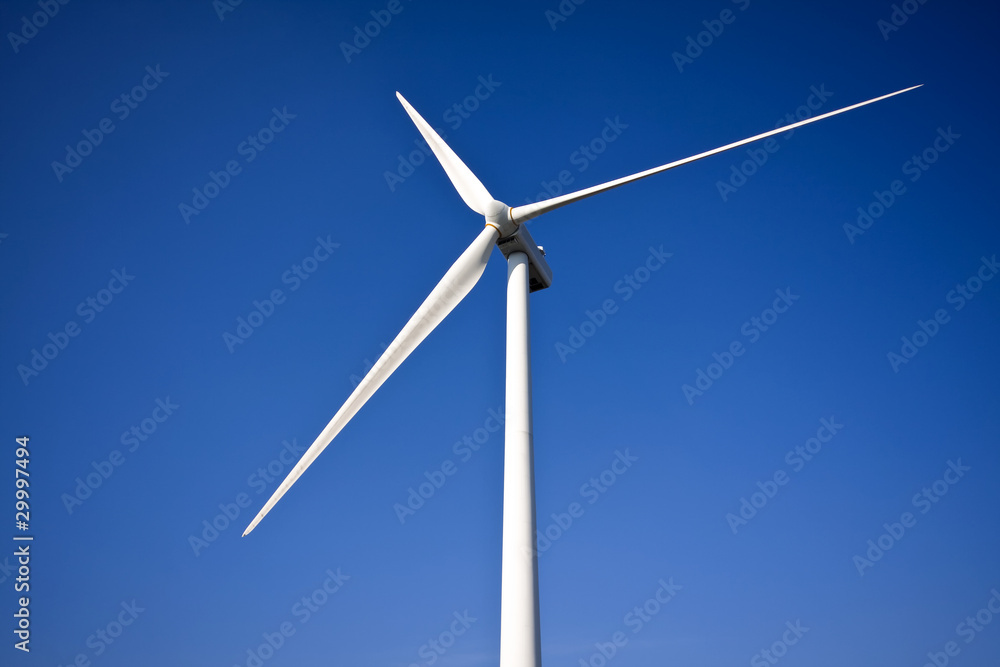 white wind turbine generating electricity on blue sky white wind turbine generating electricity on blue sky
