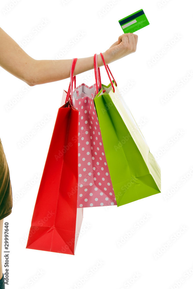 Female hand holding colorful shopping bags and credit card