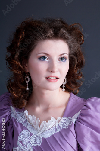 Woman lilac dress on gray background