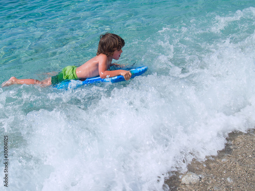 little boy learning surf in sea © neirfy