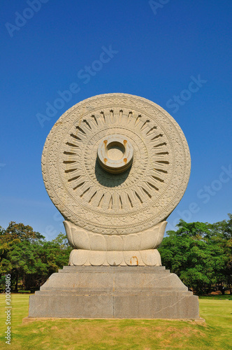 Carved stone Dhammacakra in Bangkok, Thailand photo