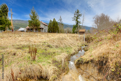 Country landscpae in a winter with a house in a distance photo