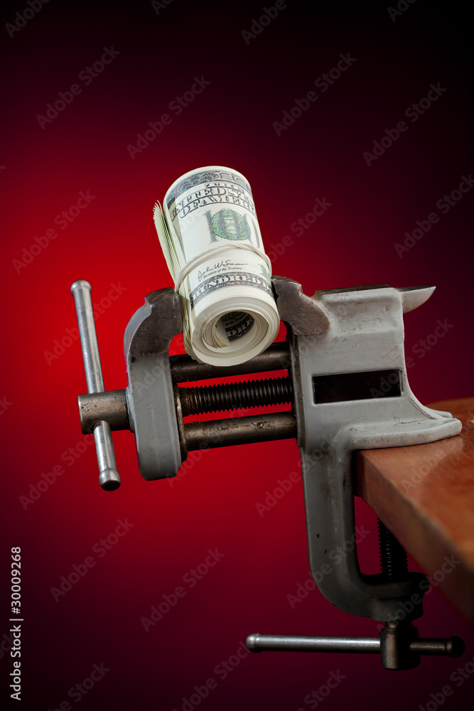 Fotografie low budget concept - money in the vice tool