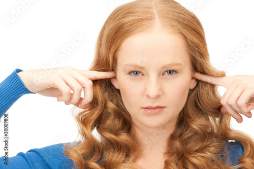 woman with fingers in ears