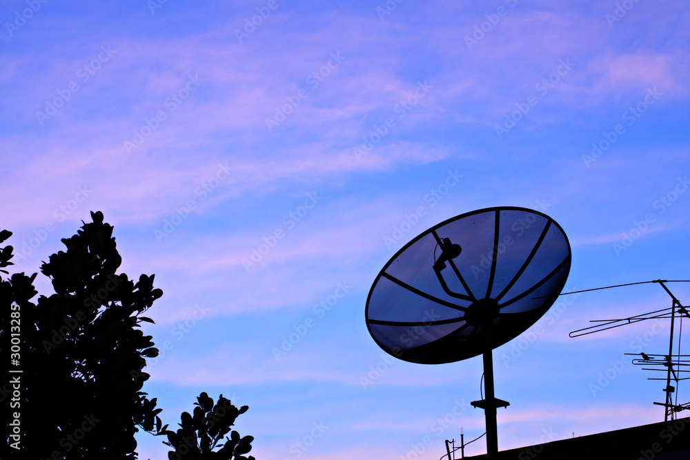 Satelite dish in twilight sky