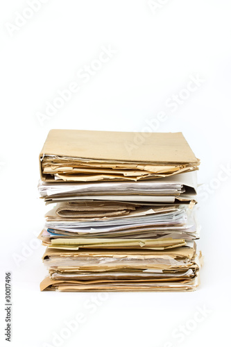 Stack of old paper files isolated on white background