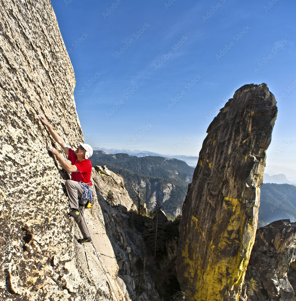 Rock climber clinging to a cliff. Rock climber clinging to a cliff.
