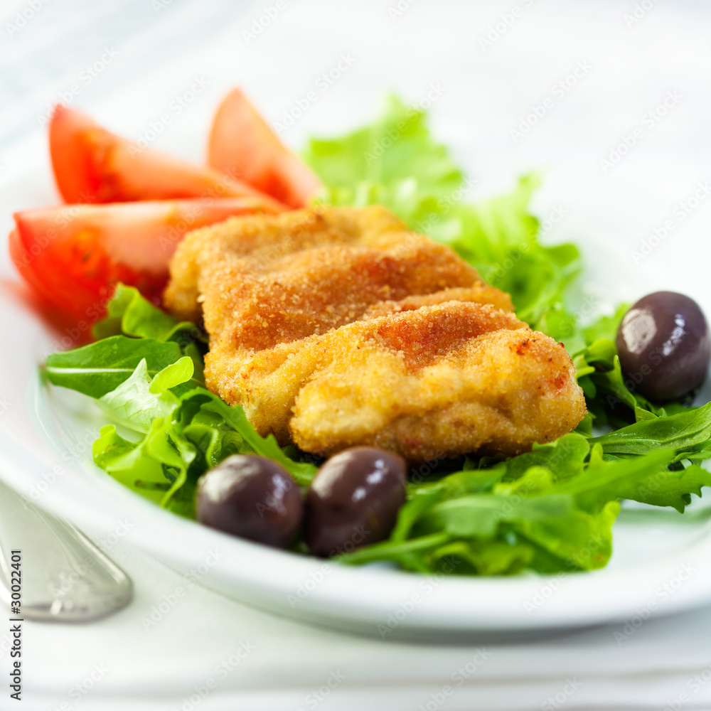 Schnitzel with vegetables and black olives Schnitzel with vegetables and black olives