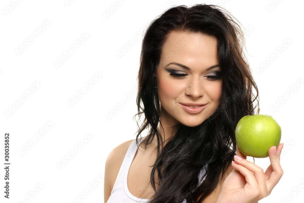 Portrait of a young brunette holding a fresh green apple Portrait of a young brunette holding a fresh green apple