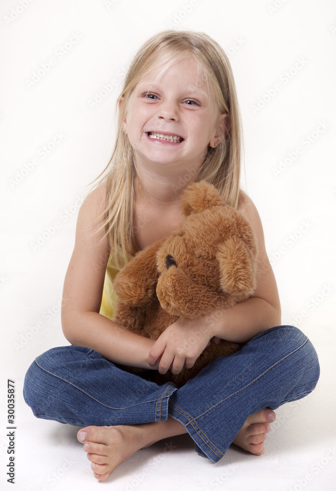 Little girl with a teddy bear smiling funny Little girl with a teddy bear smiling funny
