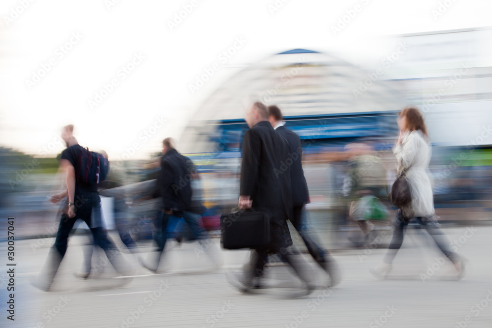 Motion blurred image of people rushing to work