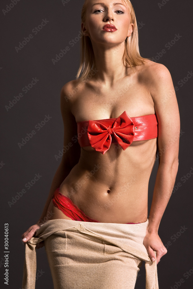 Foto de Sexy blonde woman taking off clothes do Stock | Adobe Stock