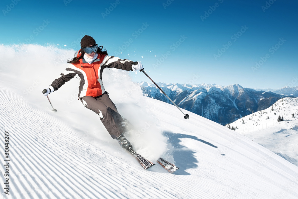 Woman skiing in high mountains - modified piste