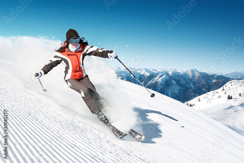 Woman skiing in high mountains - modified piste