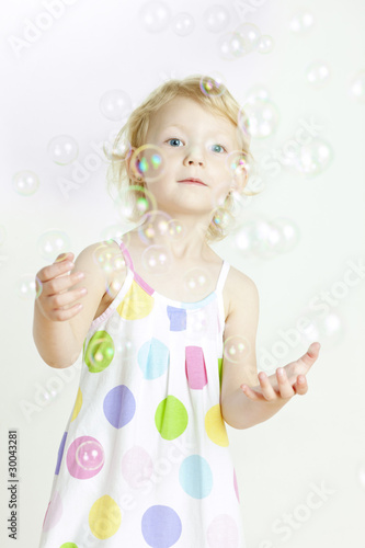 portrait of little girl with bubbles