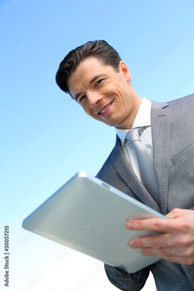 Portrait of businessman working on electronic tablet Portrait of businessman working on electronic tablet