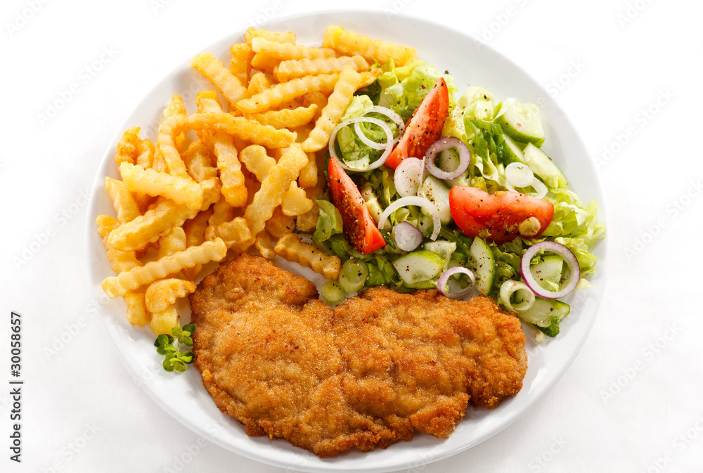 Pork chop, French fries and vegetables Pork chop, French fries and vegetables