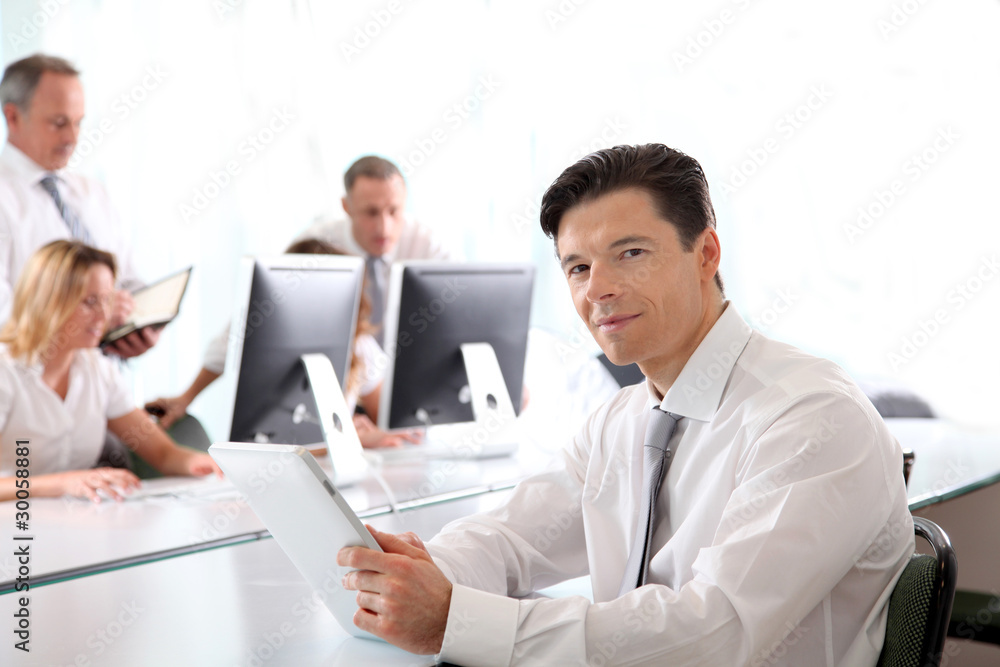 Office worker using electronic tablet in office Office worker using electronic tablet in office
