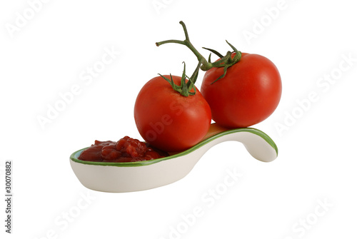 Fresh tomatoes and ketchup in decorative ceramic spoon
