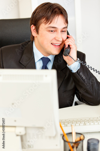 Successful businessman talking on phone.