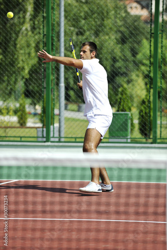 young man play tennis outdoor © .shock