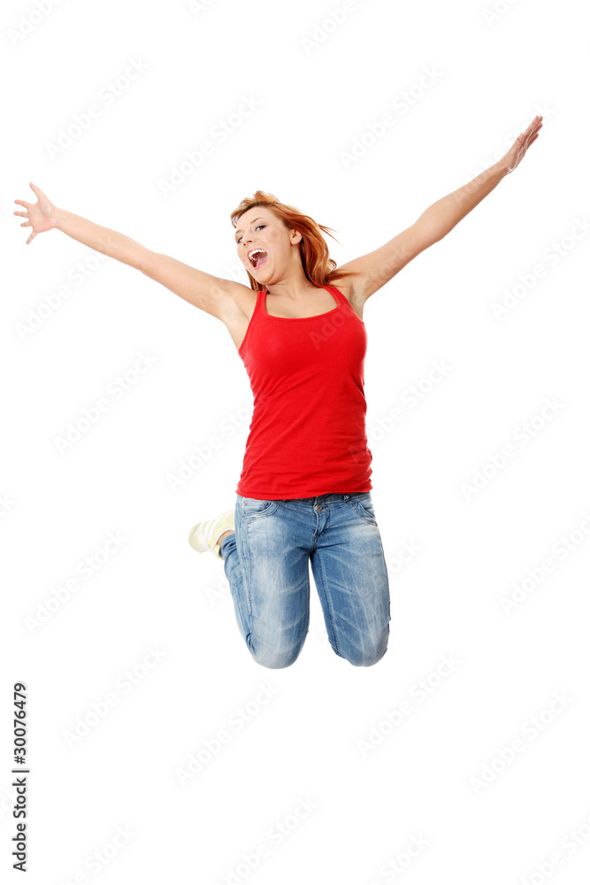 Young happy caucasian woman jumping in the air Young happy caucasian woman jumping in the air
