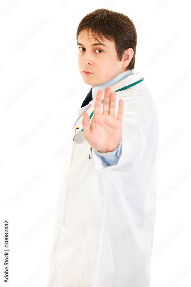 Authoritative medical doctor showing stop gesture Authoritative medical doctor showing stop gesture