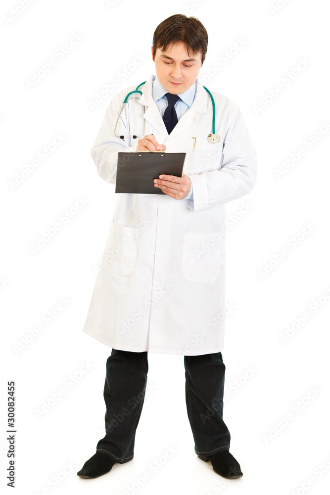 Serious doctor with stethoscope making notes in medical chart Serious doctor with stethoscope making notes in medical chart