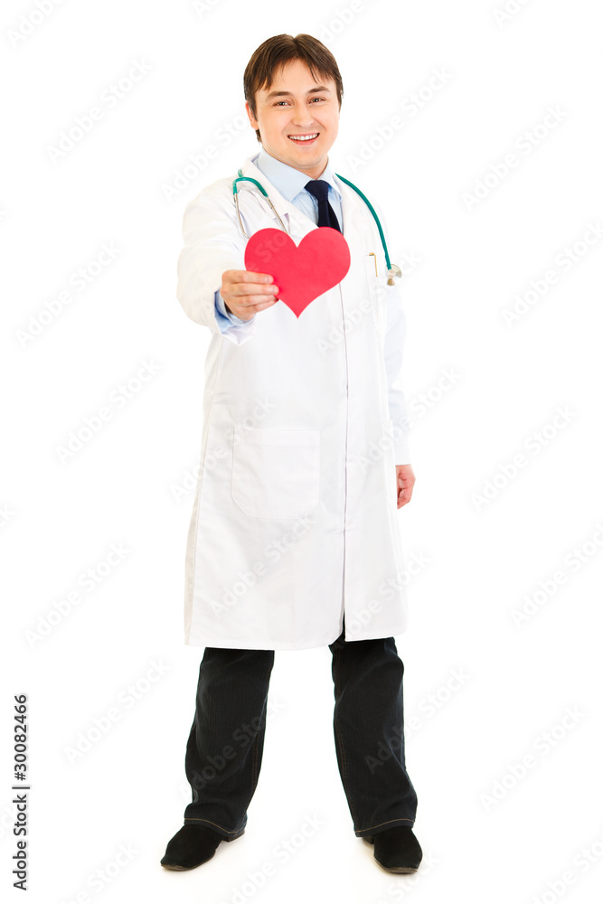 Smiling medical doctor holding paper heart in hand Smiling medical doctor holding paper heart in hand
