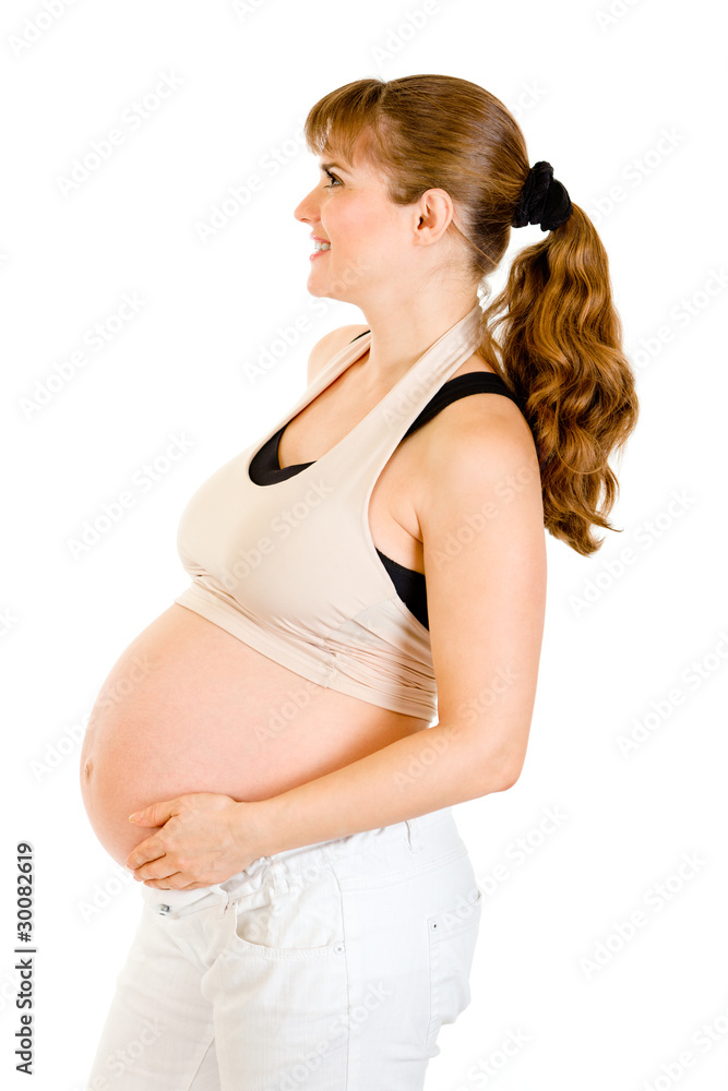 Smiling beautiful pregnant woman holding her belly Smiling beautiful pregnant woman holding her belly
