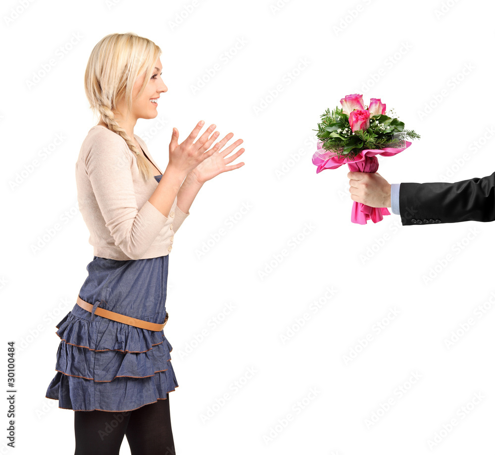 Surprised blond girl accepting bunch of flowers Surprised blond girl accepting bunch of flowers