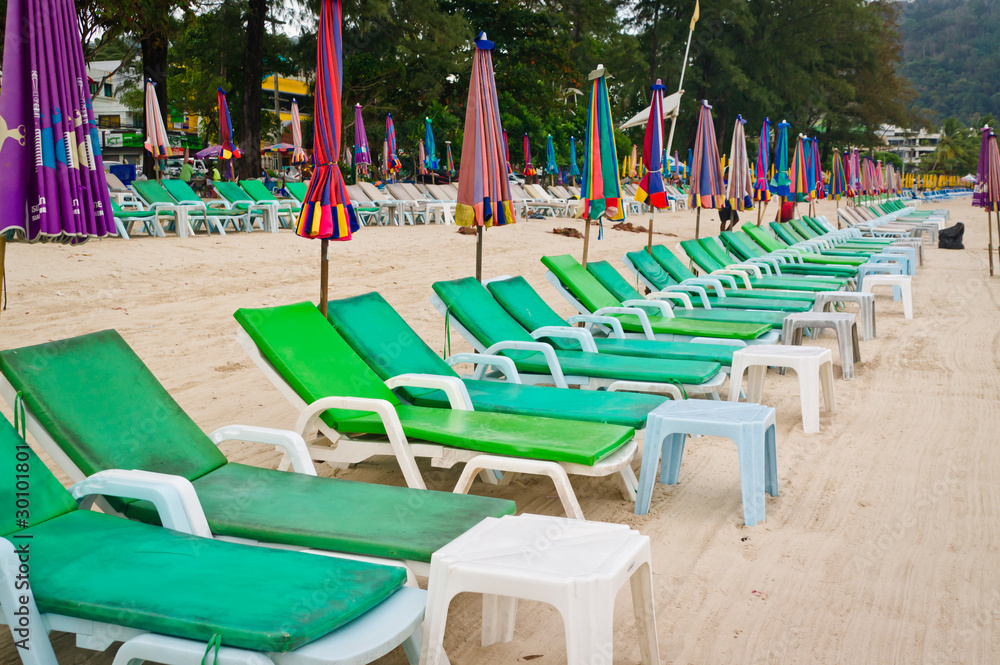 Empty chaise lounges on a beach Empty chaise lounges on a beach