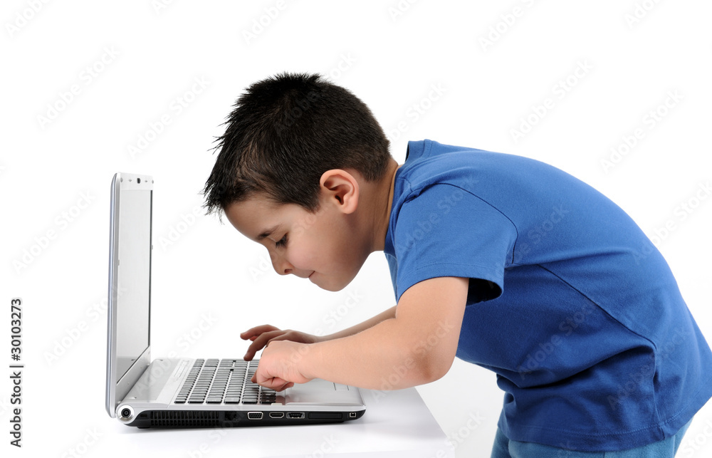 Cute child working on computer isolated on white background. Cute child working on computer isolated on white background.