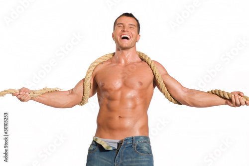 Muscular builder man with rope