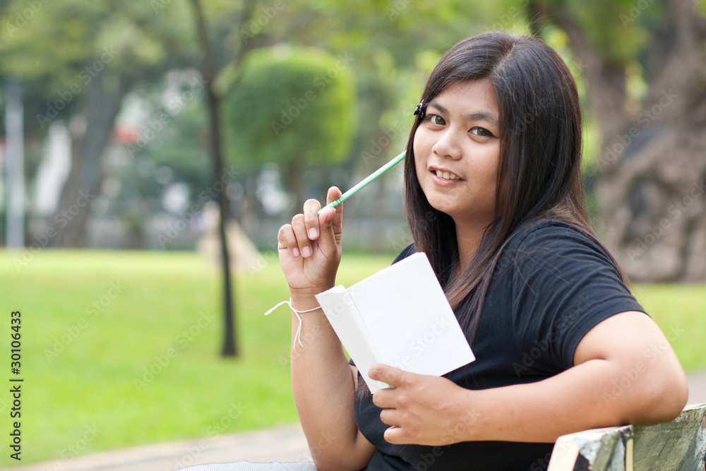 Women in the garden and holding a white card.. Women in the garden and holding a white card..