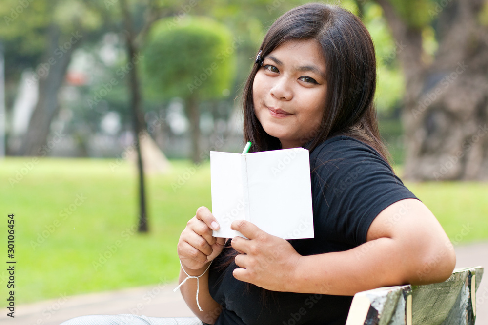 Women in the garden and holding a white card.. Women in the garden and holding a white card..